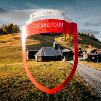 The Grandtour photo spot in Obermutten with the wooden church in the center