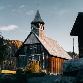 The wooden church of Obermutten in the fall